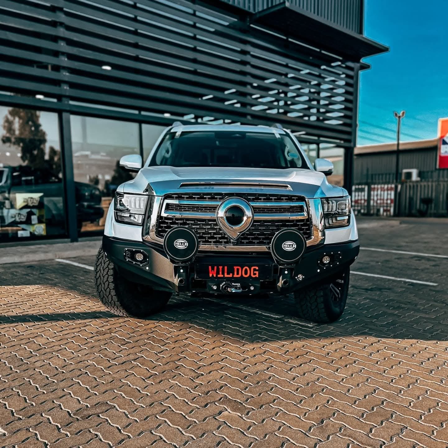 White GWM P-500 truck with a K9 Style 'WILDOG' front bumper equipped with the WILDOG branding on the license plate.